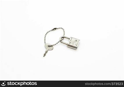Small padlock and key for bag or suitcase isolated on white background