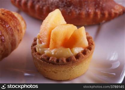 Small peach pastry over a ceramic plate