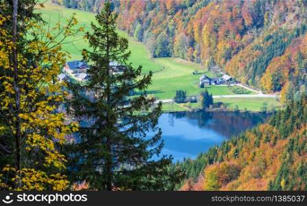 Small picturesque autumn Alps mountain lake Krotensee view from path to Schafberg viewpoint from Winkl, Salzkammergut, Upper Austria. Beautiful hiking, seasonal, and nature beauty concept scene.