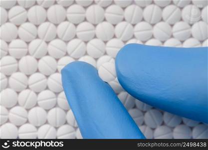 Small pill in scientist hand. Drugs medicine laboratory research.