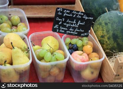 Small plastic baskets with assorted fruit on a local market in the Provence, France