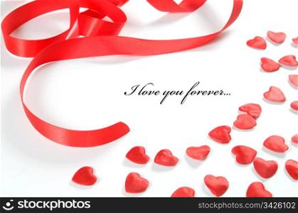 Small red hearts and ribbon on white background. Composition for themes like love, valentine&rsquo;s day, holidays with space for your text