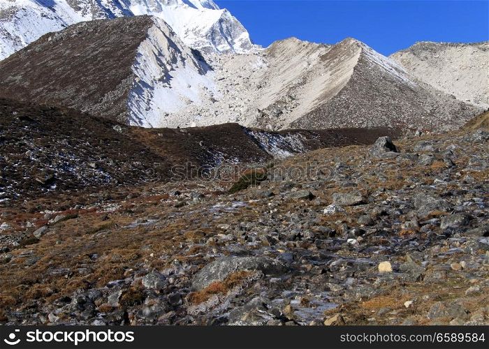 Small river and slope on mount Manaslu in Nepal