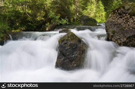 small river and waterfall at summer