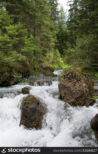 small river and waterfall at summer