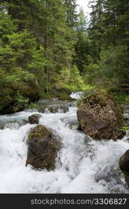 small river and waterfall at summer