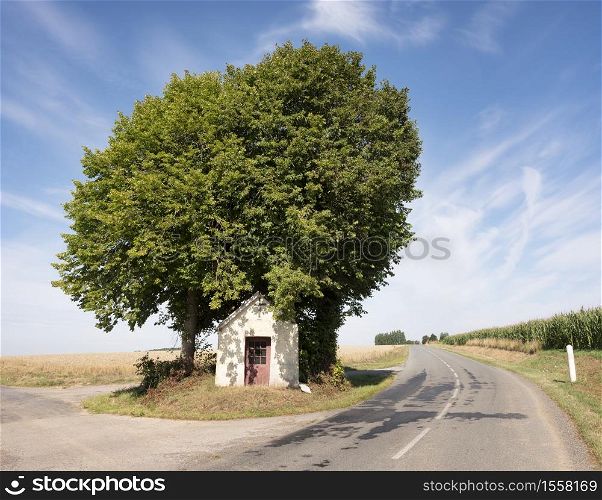 small roadside chapel in rural landscape of nord pas de calais in northern france
