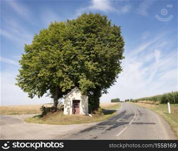 small roadside chapel in rural landscape of nord pas de calais in northern france