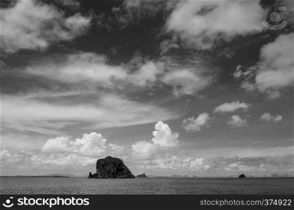 Small rock island near Koh Lanta, Krabi on clear blue sky day, calm Andaman sea in Thailand - Black and white