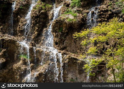 Small rocky waterfall pouring into a small pool