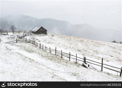 Small rural house in the white winter mountains