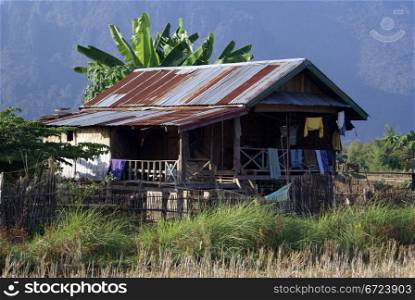 Small rusty house in village, North Laos