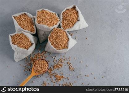 Small sack filled with buckwheat with heap. Important cereal for humans. Top view. Organic product. Free space for your information
