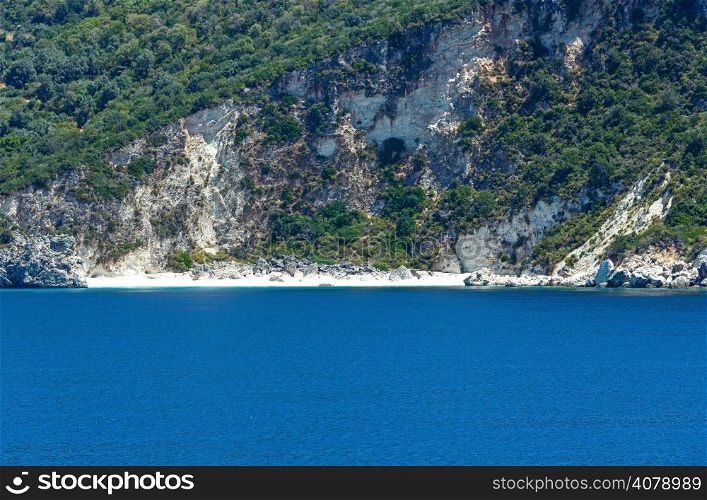Small sandy beach and summer coast view from train ferry (Kefalonia, Greece)