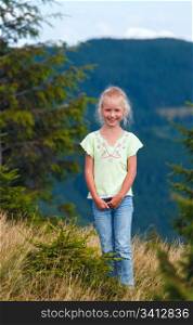 Small smiling girl in summer Carpathian mountain