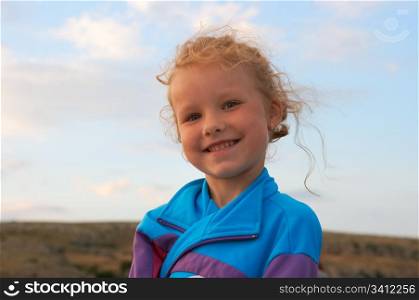 Small smiling girl outdoor portrait