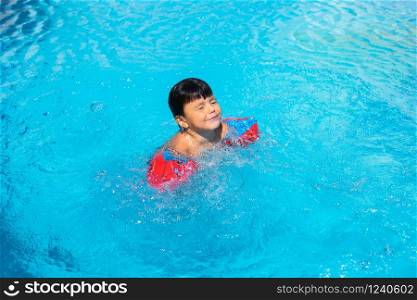 Small spanish boy swimming in pool. Summer vacation.