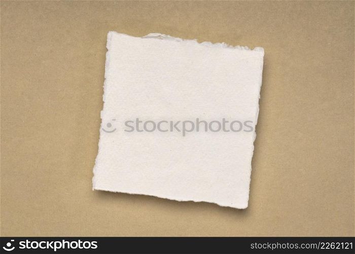 small square sheet of blank white Khadi paper against beige rag paper