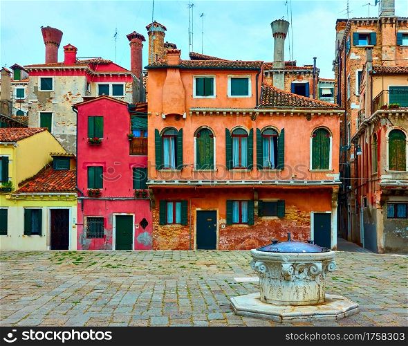 Small square with colorful houses in Venice, Italy. Venetian cityscape