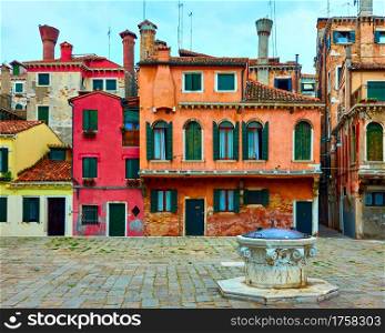 Small square with colorful houses in Venice, Italy. Venetian cityscape
