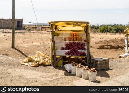 Small stall of fruits and vegetables . Small stall of fruits and vegetables on a dirt road in Masai Mara Park in North West Kenya