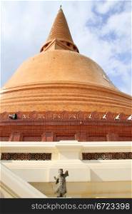 Small statue and big stupa Chedi Phra Pathom in Thailand