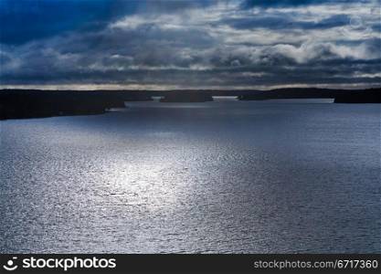 small stone islands with forest in swedish fiord under moonlight