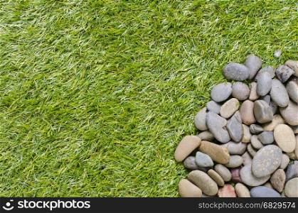 small stone on grass background
