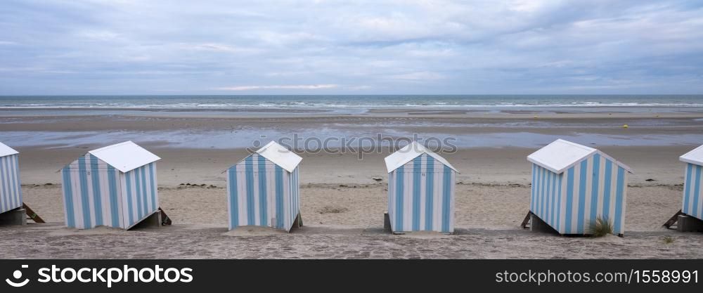 small striped beach huts in hardelot plage on the coast of normandy in france