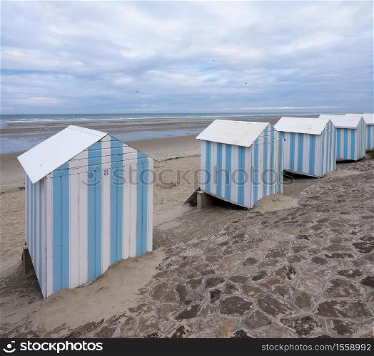 small striped beach huts in hardelot plage on the coast of normandy in france