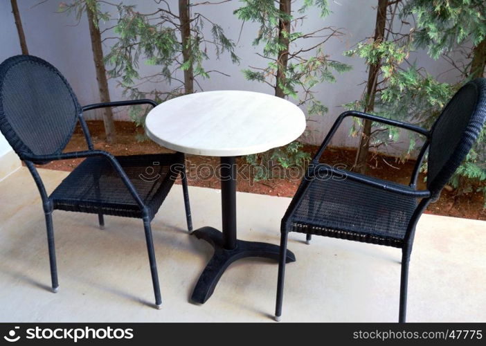 Small terrace to contain with a table and two chairs.