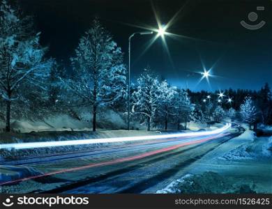Small town street traffic on dark cold winter evening. Winter street traffic
