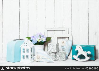 Small toy house, pony, bricks in the children&rsquo;s room on wooden background. Blue room decor