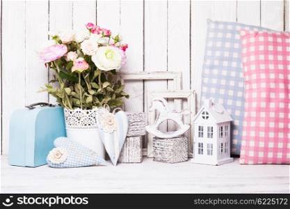 Small toy house, pony, pillows in the children&amp;#39;s room on wooden background