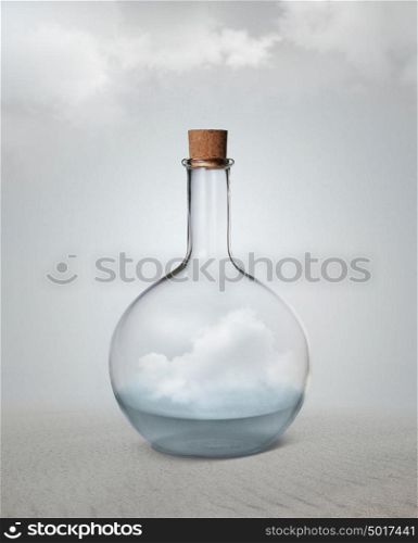 Small vintage glass bottle with water and cloud inside standing among desert.