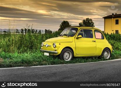 Small vintage italian car Fiat Abarth. Yellow color