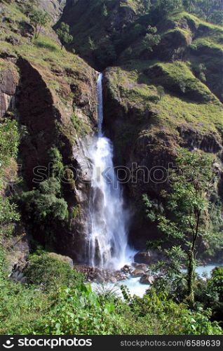 Small waterfall and rock in mountain Nepal