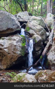 small waterfall cascade in the stream in northern thailand