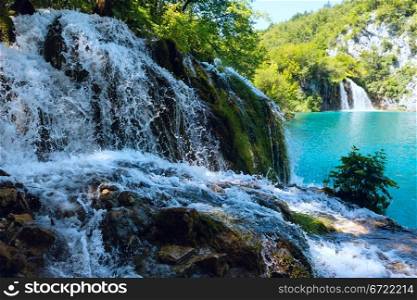 Small waterfall (closeup) and azure limpid lake in Plitvice Lakes National Park (Croatia)
