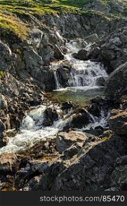 Small waterfall near Honningsvag, Norway. Honningsvag in Norway