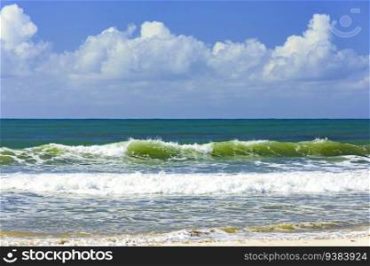 Small waves on the shore on a sunny summer day and vividly colored water on the coast of Bahia, Brazil. Small waves on the shore on a sunny summer day