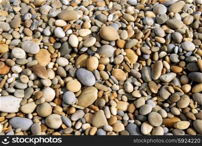 small wet pebble stones at the beach