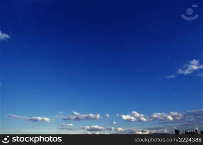 Small White Clouds In A Clear Blue Sky