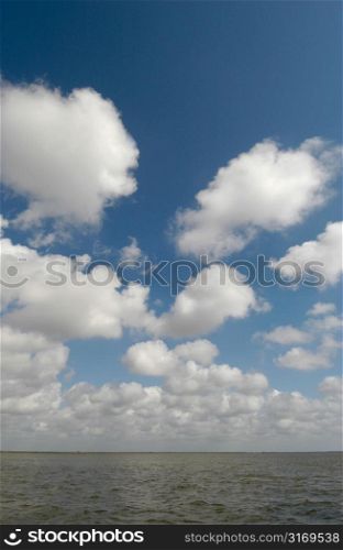 Small White Clouds Over The Ocean