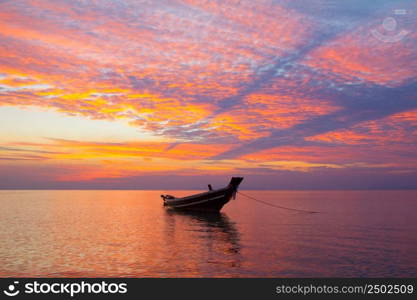 Small wooden fisherman boat at sunset