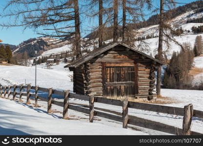 Small Wooden Shack and Fence Among Trees in Winter day with Fresh Snow in the Mountains. Small Wooden Shack and Fence Among Trees in Winter day with Fres