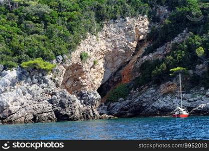 Small yacht anchored at scenic rocks near Dubrovnik, Croatia