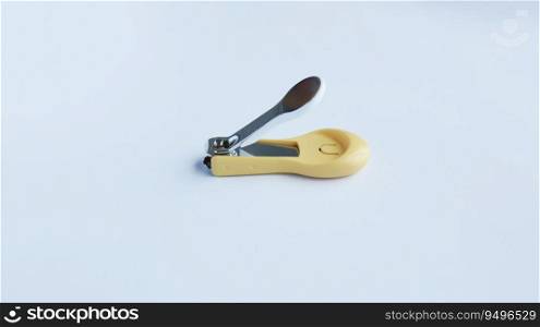 Small yellow white fancy nail clipper isolated on white for baby or kid.