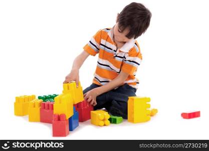 Smart boy playing with blocks on white isoalted background