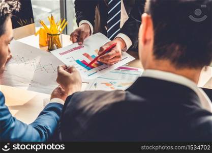 Smart businessman and businesswoman talking discussion in group meeting at office table in a modern office interior. Business collaboration strategic planning and brainstorming of coworkers.